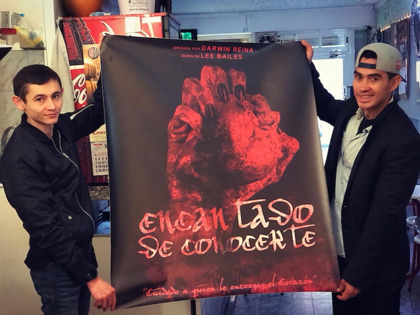 Darwin and Rinat hold the poster